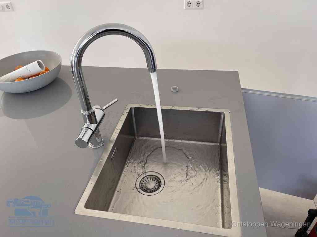 Een vrij doorstromende rvs spoelbak waar het water moeiteloos wegloopt, het resultaat van slim onderhoud dat geld bespaart in Wageningen